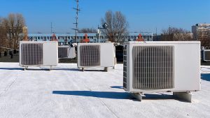 Air conditioners on the roof of the house, air conditioning system on the roofs of houses in warm countries, white roof