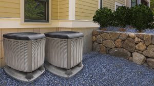 HVAC heating and air conditioning residential units on the side of a house.